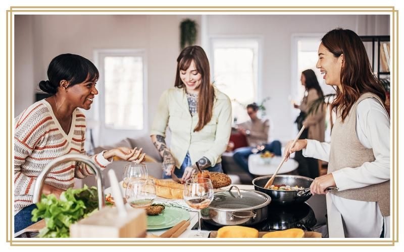 a group of women cooking in a kitchen