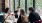 a group of people sitting at a table with wine