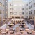 a courtyard with tables and chairs