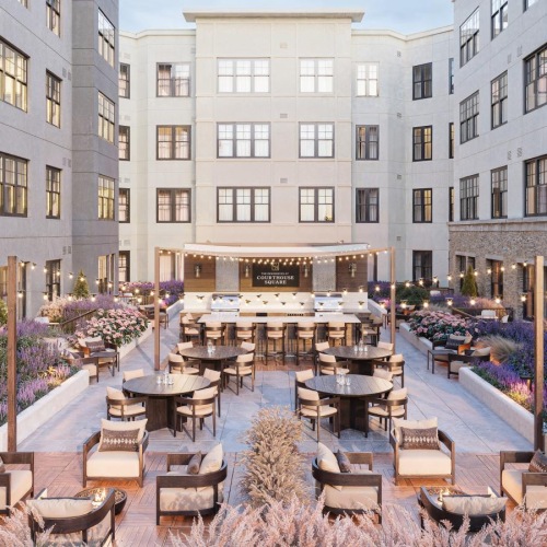 a courtyard with tables and chairs